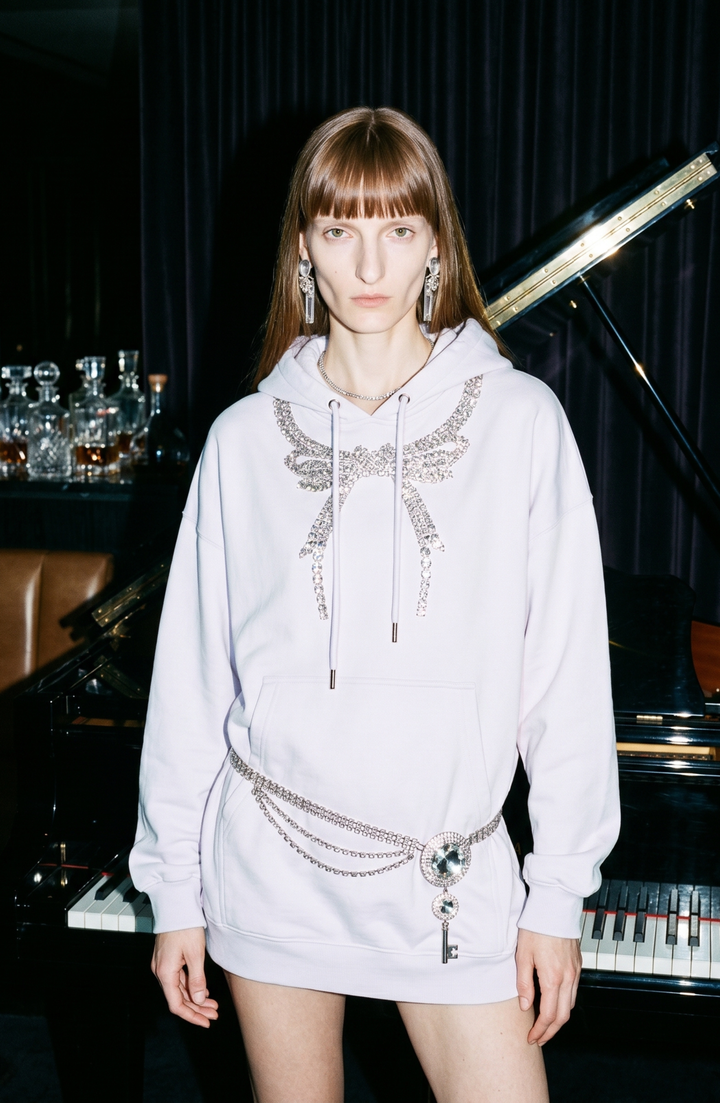 Black pullover hoodie with embellished wing detail, hood, drawstrings and front pouch pocket