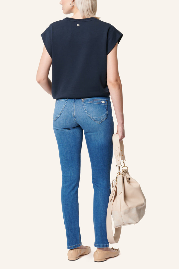 Women's blue slim fit jeans with studded rear pocket detail