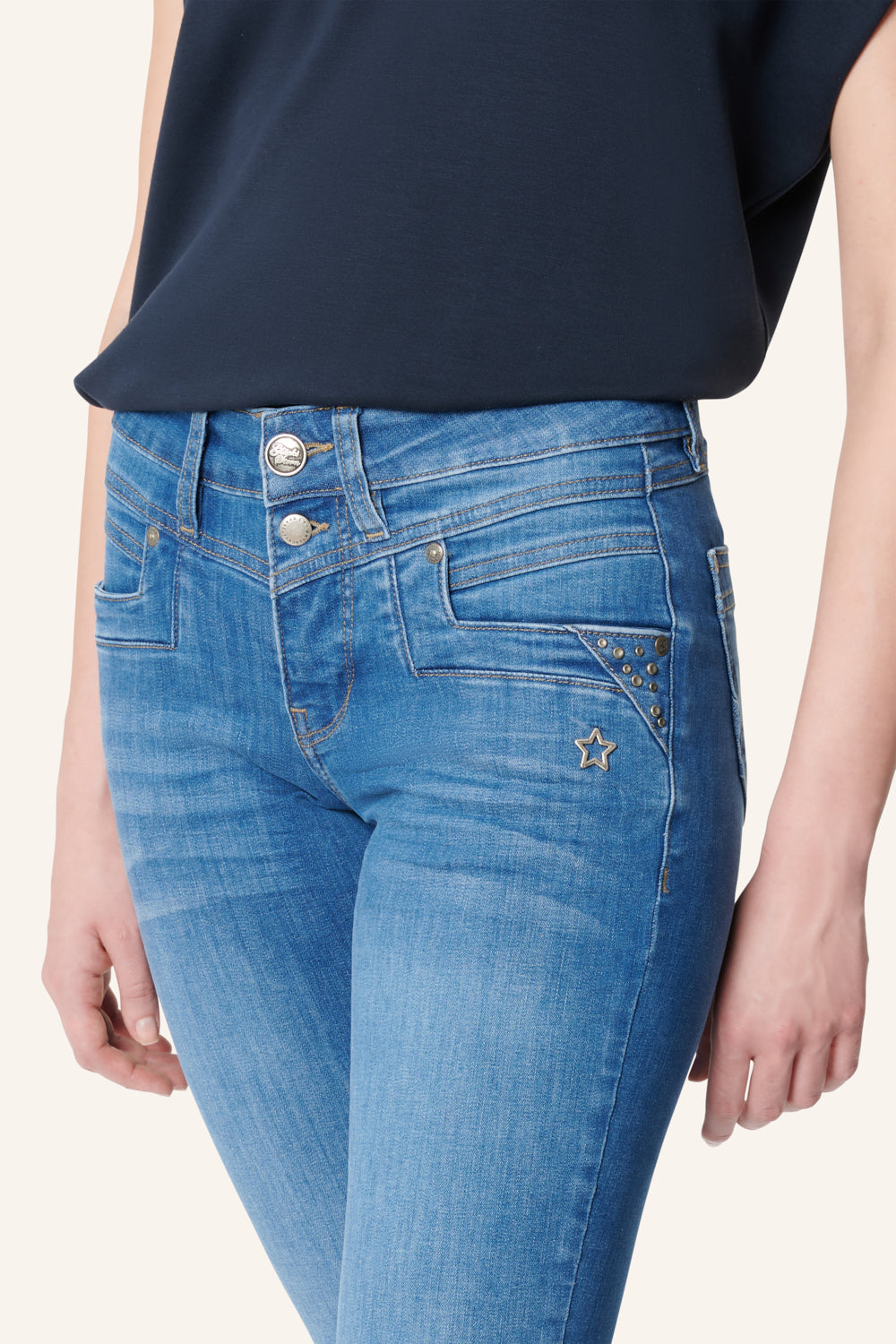 Women's blue slim fit jeans with studded rear pocket detail