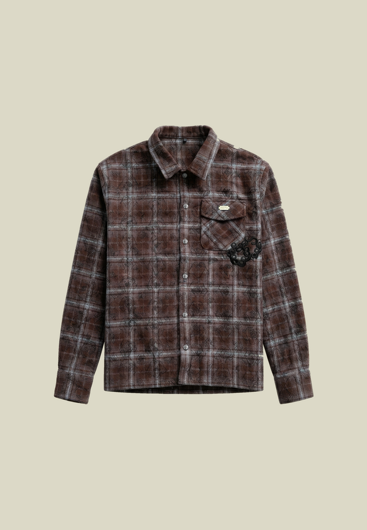 Brown plaid flannel shirt with long sleeves and decorative detailing