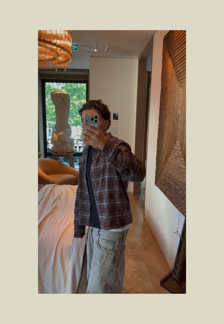 Brown plaid flannel shirt with long sleeves and decorative detailing