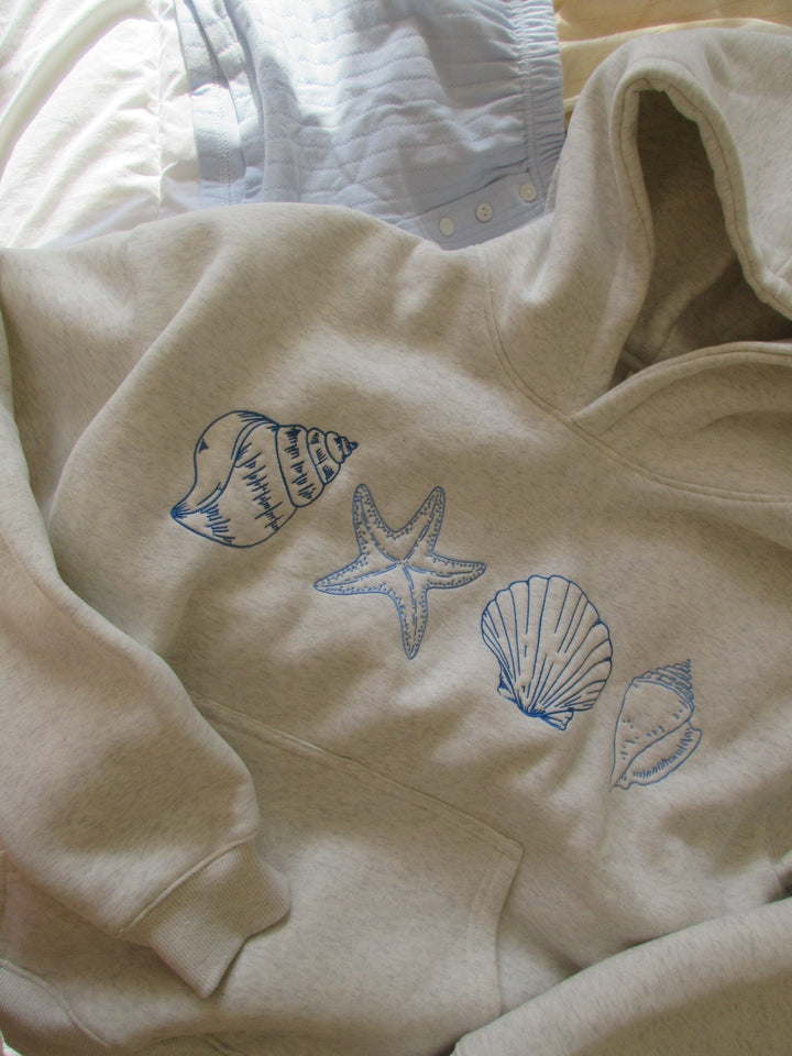 Gray unisex hoodie sweatshirt with blue seashell and starfish prints