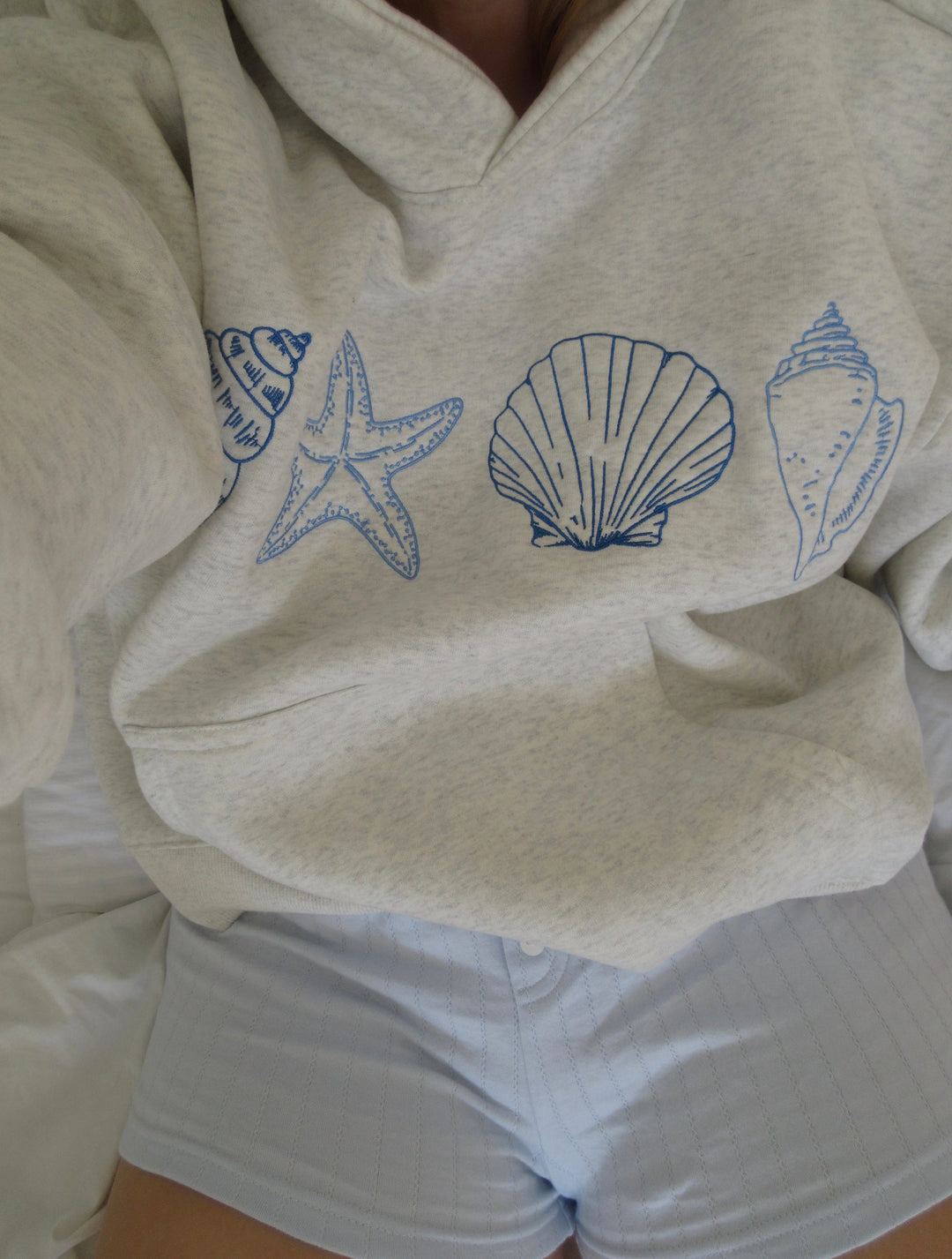 Gray unisex hoodie sweatshirt with blue seashell and starfish prints