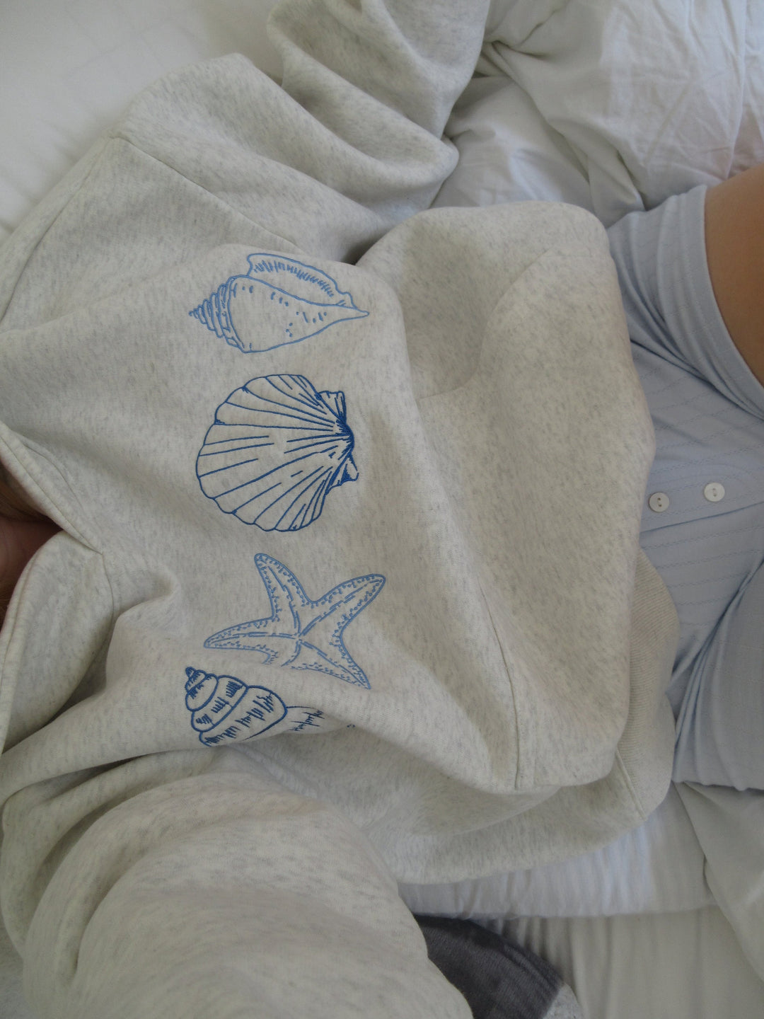 Gray unisex hoodie sweatshirt with blue seashell and starfish prints