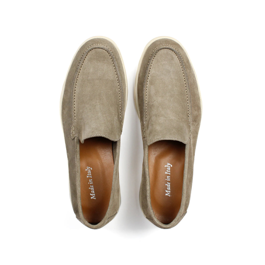 Beige moccasin loafers with rounded toes, stitched detailing and low soles