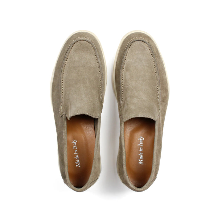 Beige moccasin loafers with rounded toes, stitched detailing and low soles
