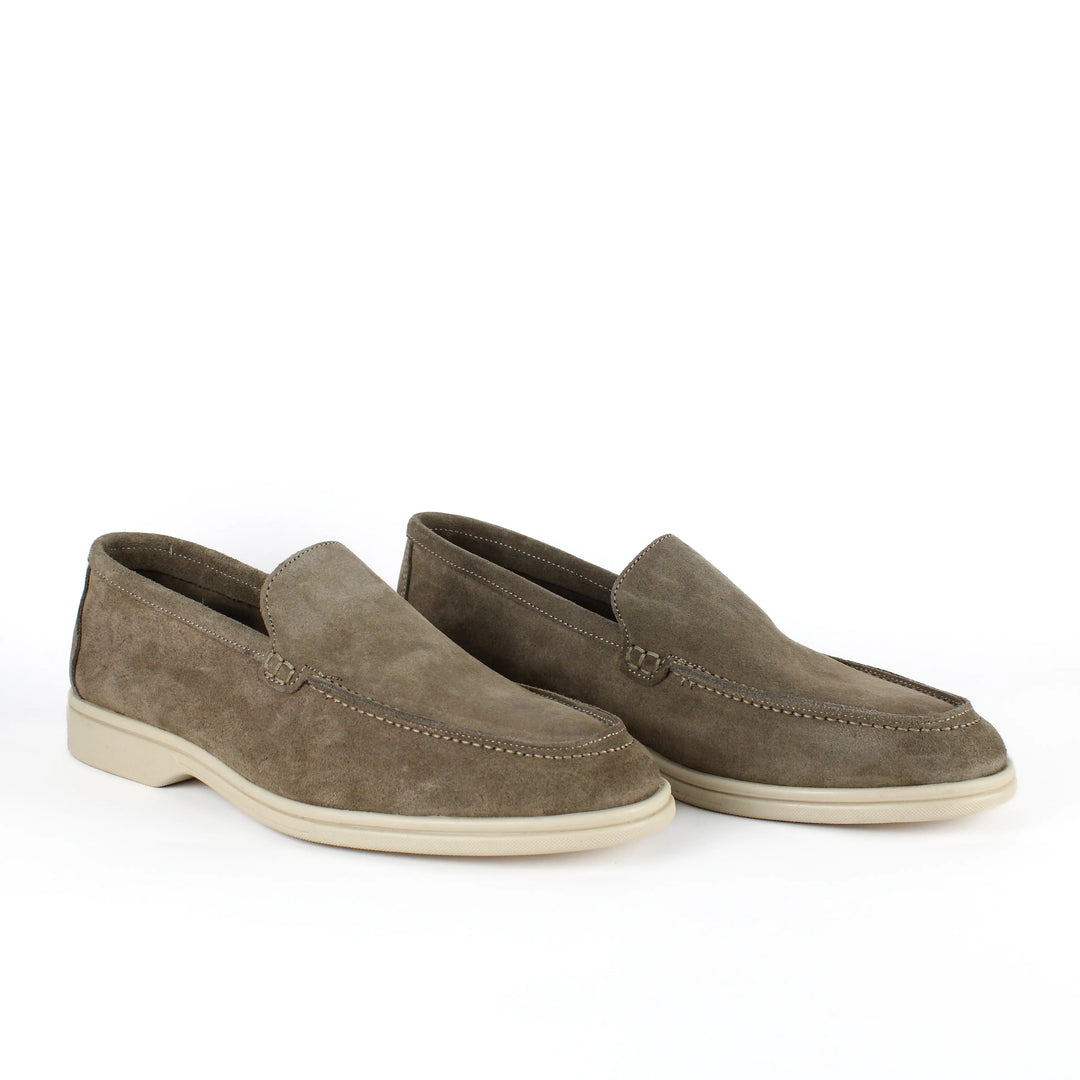 Beige moccasin loafers with rounded toes, stitched detailing and low soles