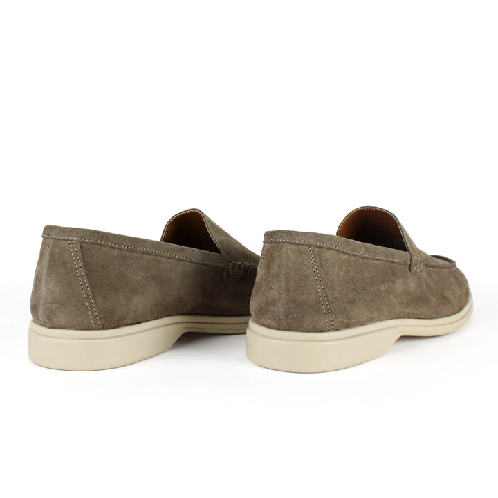 Beige moccasin loafers with rounded toes, stitched detailing and low soles