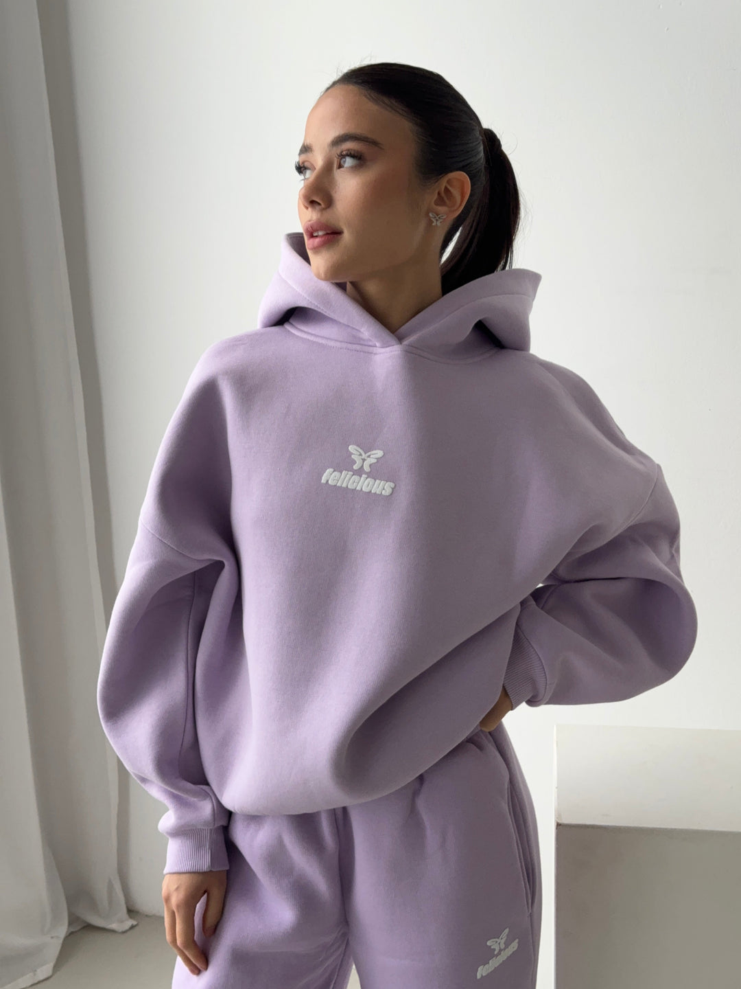 Women's lavender hooded sweatshirt with long sleeves and front logo