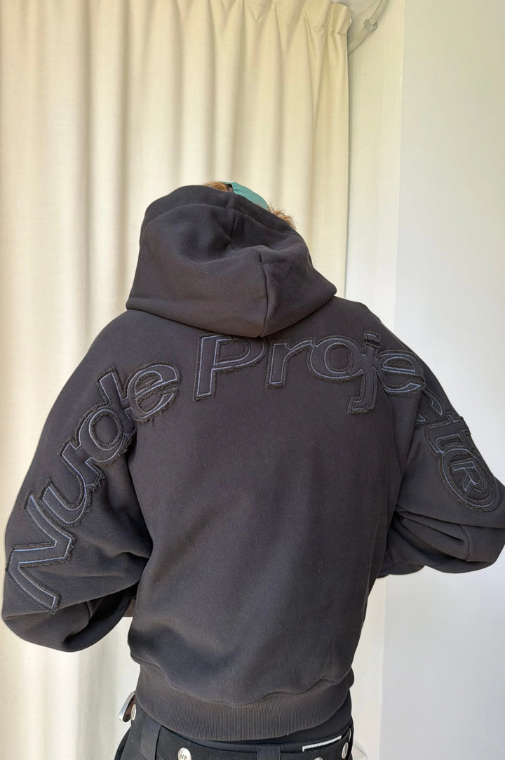 Black hooded sweatshirt with raised lettering on the back and sleeves