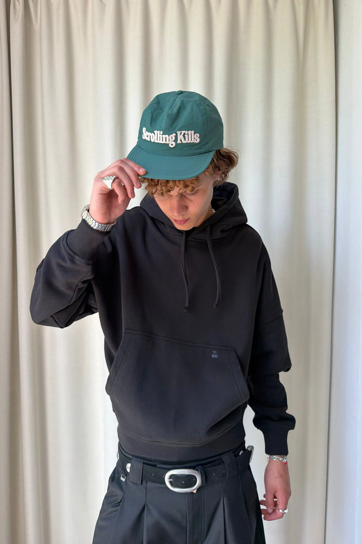 Black hooded sweatshirt with raised lettering on the back and sleeves