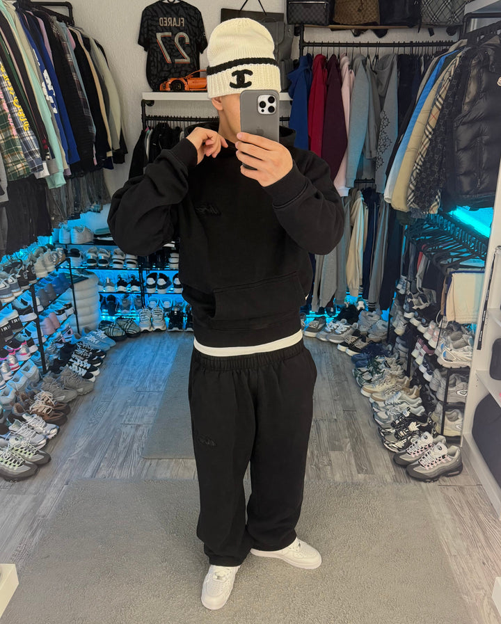 Black pullover hoodie with hood, long sleeves and kangaroo pocket