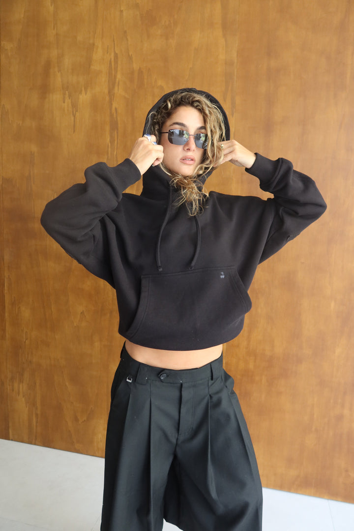 Black hooded sweatshirt with raised lettering on the back and sleeves