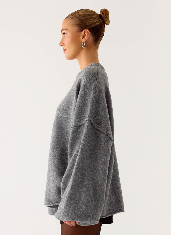 Women's grey oversized knit sweater with crew neck and wide bell sleeves