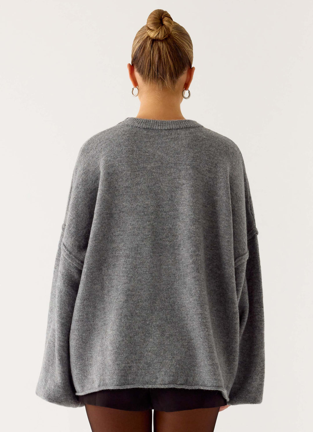 Women's grey oversized knit sweater with crew neck and wide bell sleeves