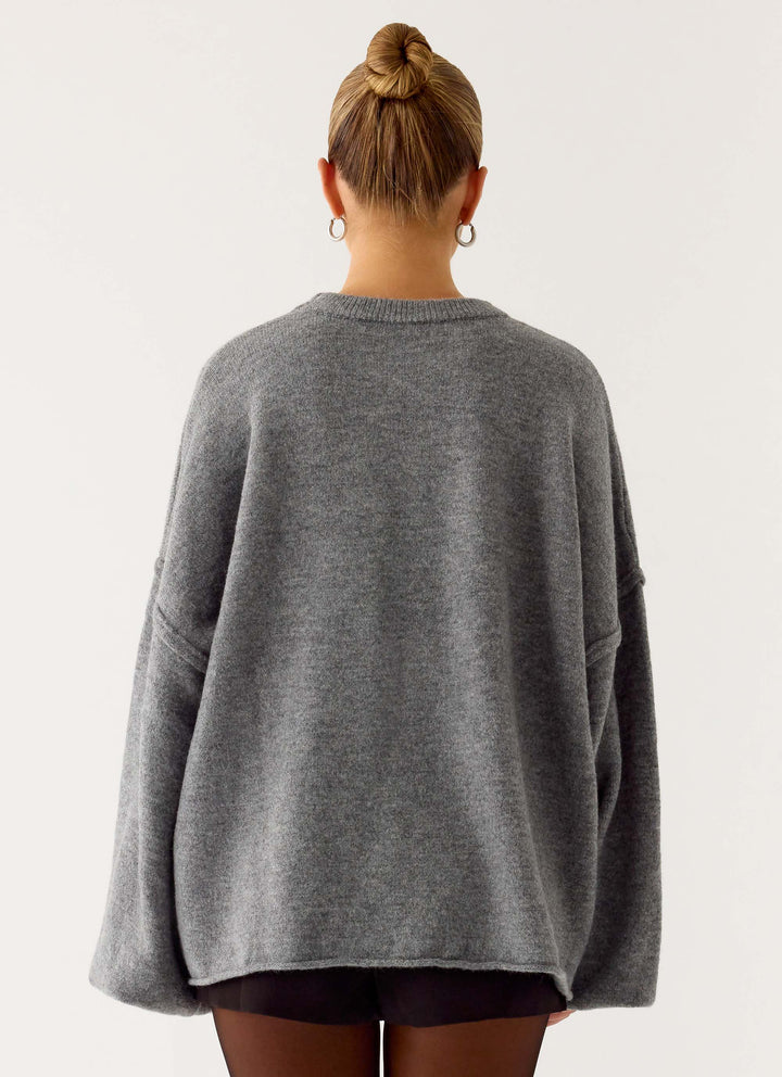 Women's grey oversized knit sweater with crew neck and wide bell sleeves