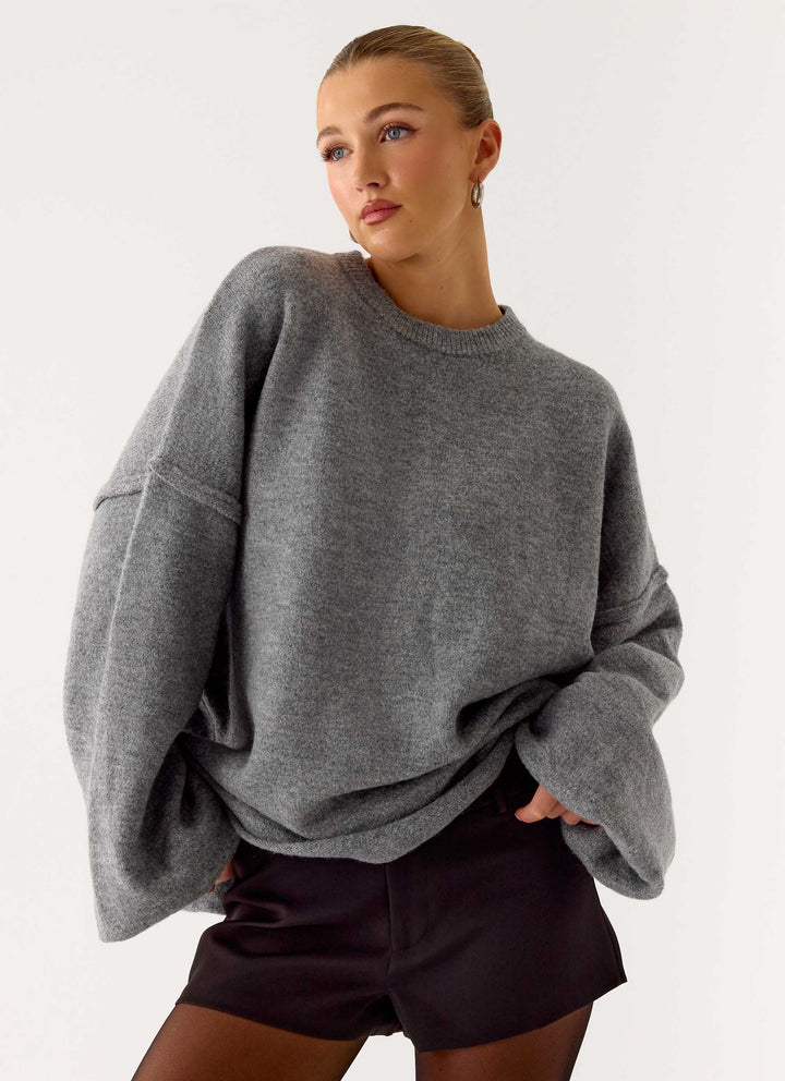 Women's grey oversized knit sweater with crew neck and wide bell sleeves