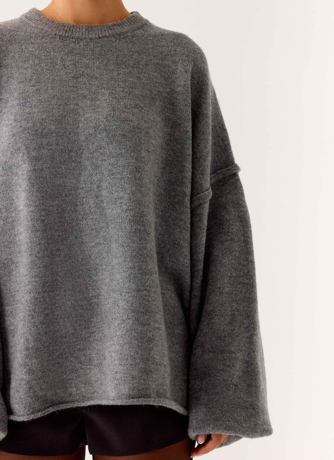 Women's grey oversized knit sweater with crew neck and wide bell sleeves