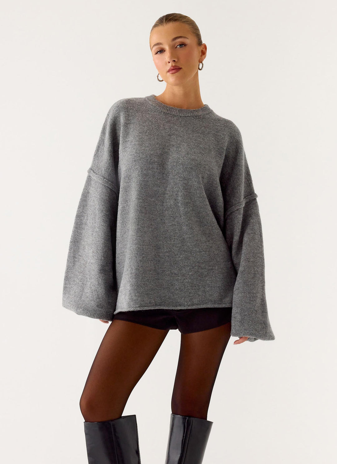 Women's grey oversized knit sweater with crew neck and wide bell sleeves
