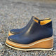 Women's ankle boots with rounded toes, side zippers and layered wedge soles