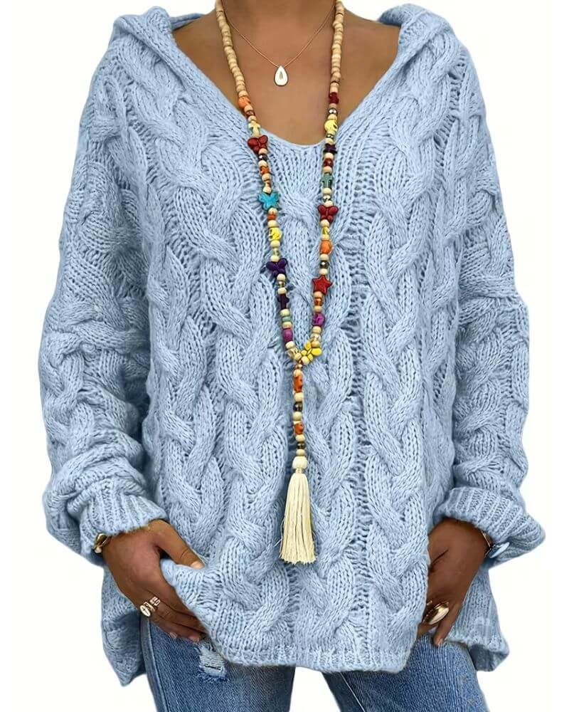 Women's hooded cable knit sweater with long sleeves and oversized fit