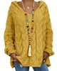 Women's hooded cable knit sweater with long sleeves and oversized fit