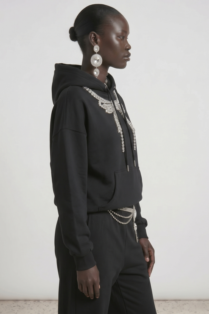 Black pullover hoodie with embellished wing detail, hood, drawstrings and front pouch pocket