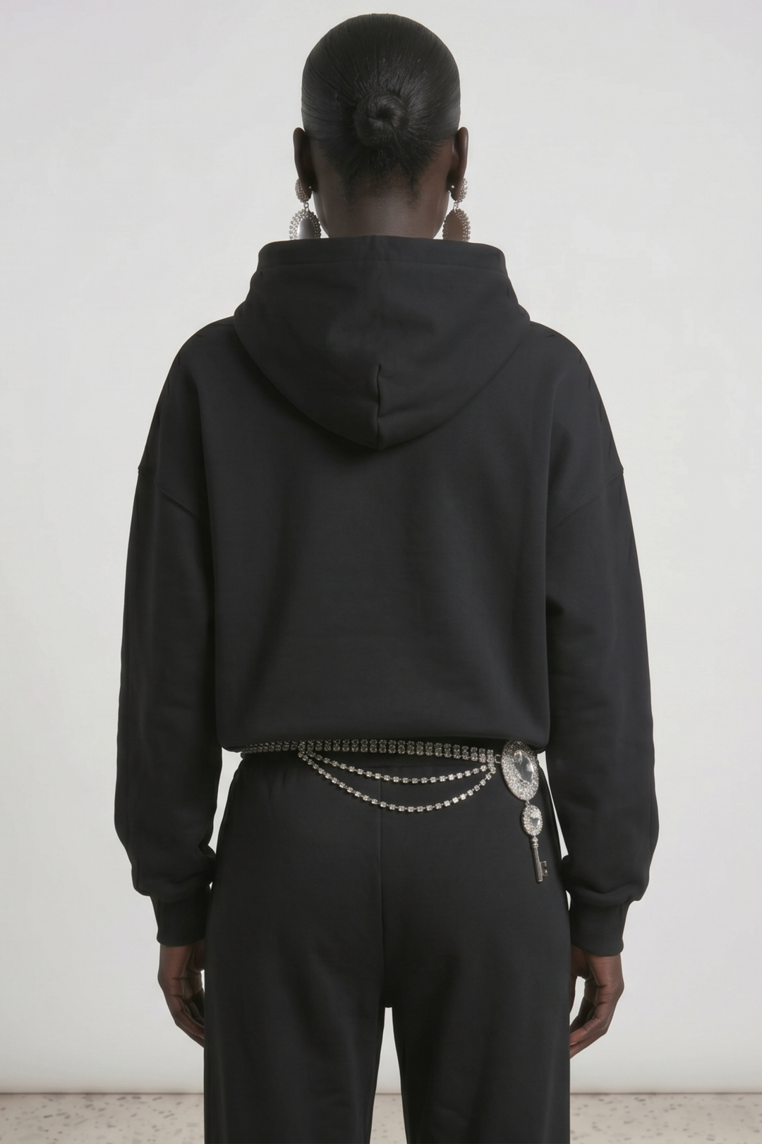 Black pullover hoodie with embellished wing detail, hood, drawstrings and front pouch pocket