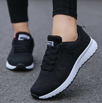 Women's low-top lace-up sneakers with textured upper and flat sole