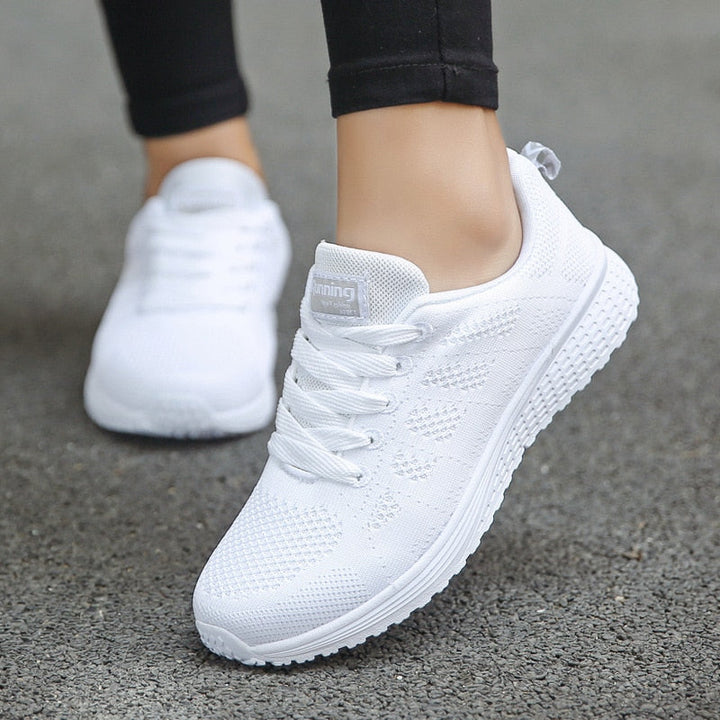 Women's low-top lace-up sneakers with textured upper and flat sole