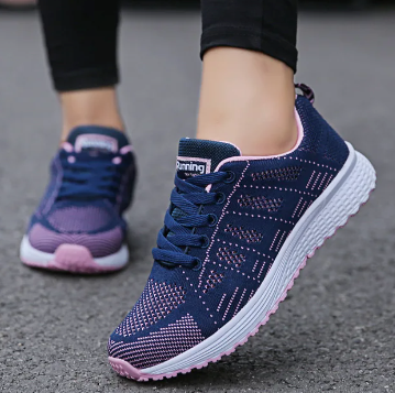 Women's low-top lace-up sneakers with textured upper and flat sole