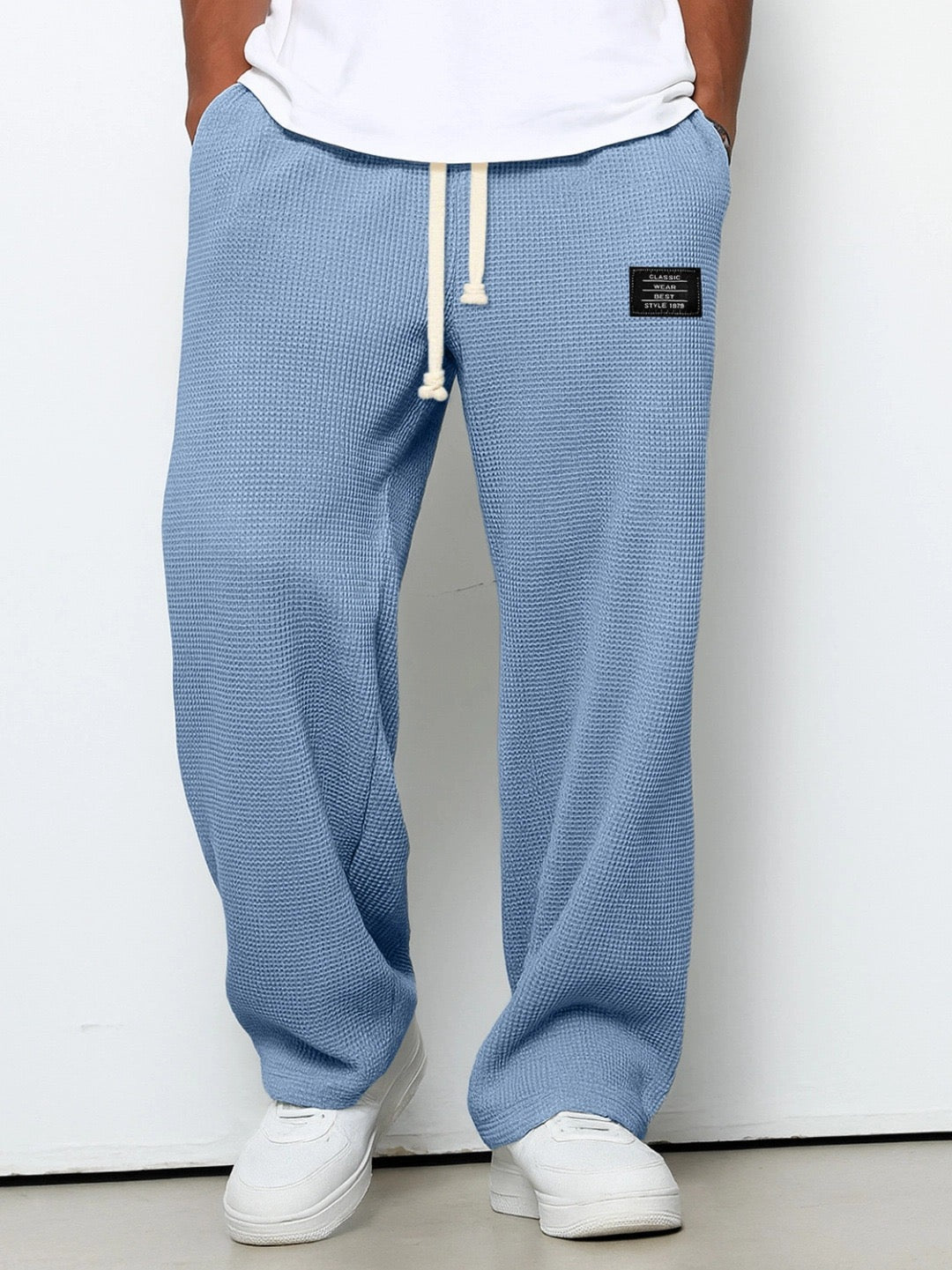 Wide leg trousers with adjustable drawstring waist and textured finish