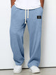 Wide leg trousers with adjustable drawstring waist and textured finish