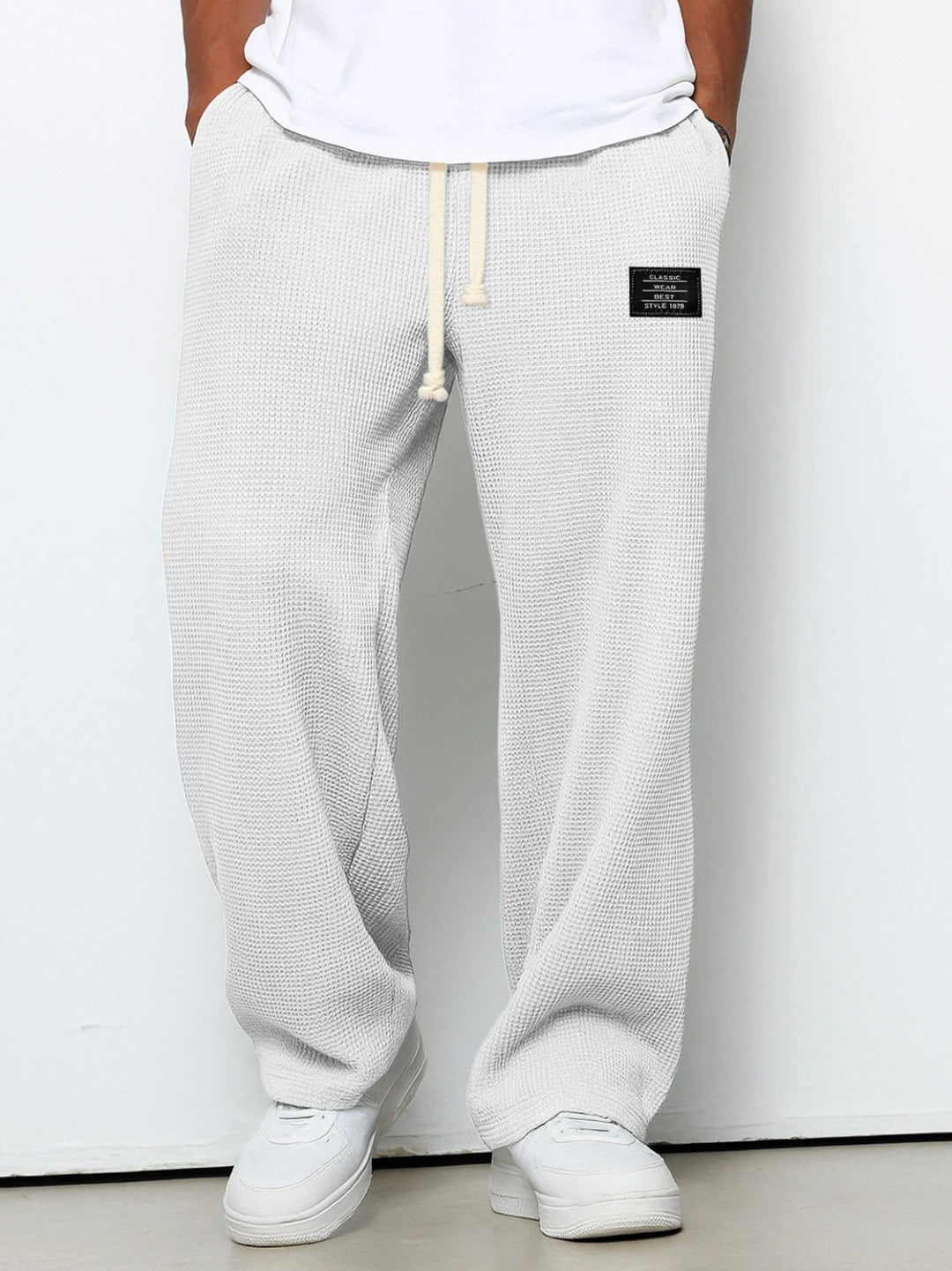 Wide leg trousers with adjustable drawstring waist and textured finish