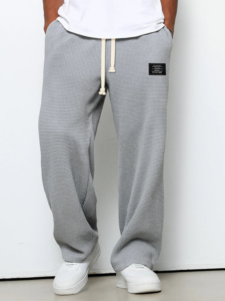 Wide leg trousers with adjustable drawstring waist and textured finish