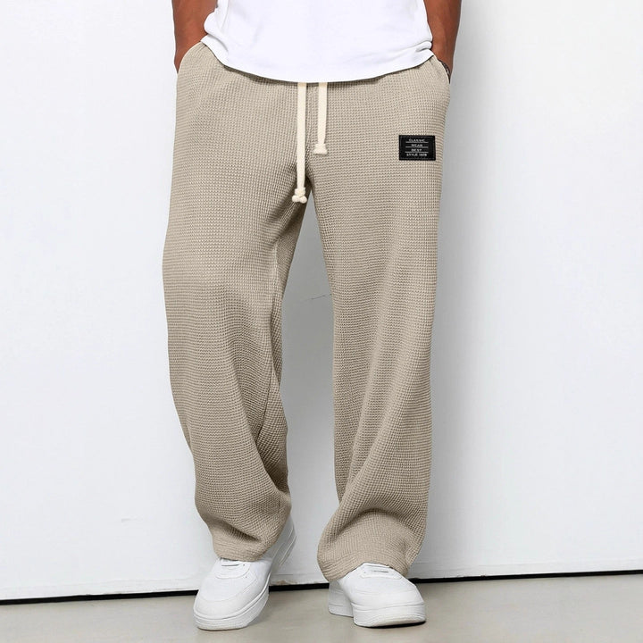 Wide leg trousers with adjustable drawstring waist and textured finish