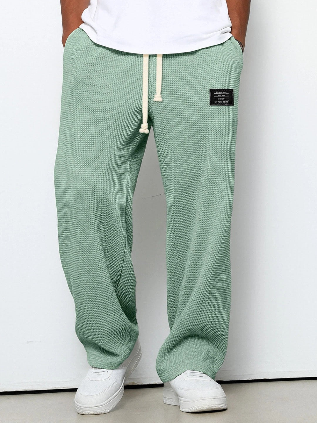 Wide leg trousers with adjustable drawstring waist and textured finish