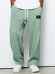 Wide leg trousers with adjustable drawstring waist and textured finish