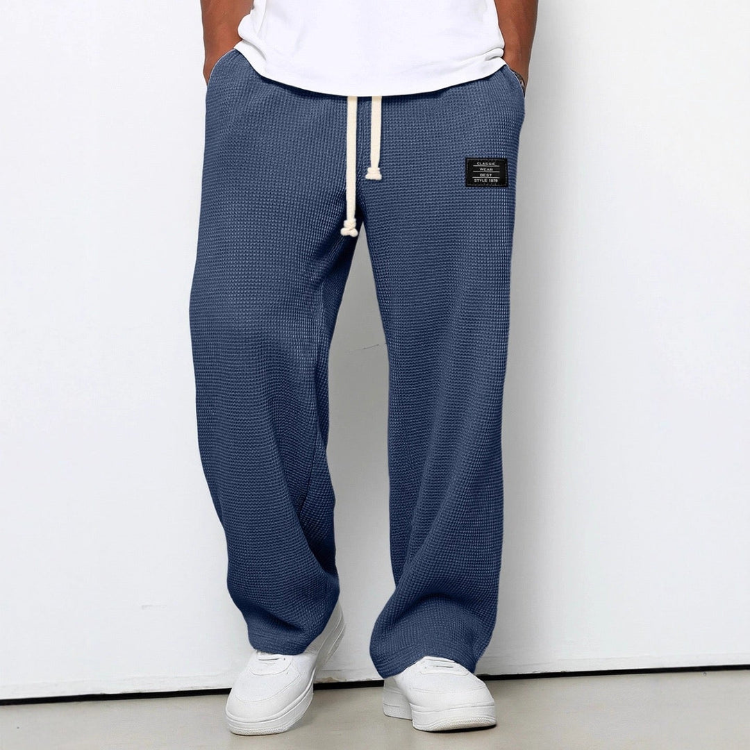 Wide leg trousers with adjustable drawstring waist and textured finish