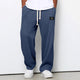 Wide leg trousers with adjustable drawstring waist and textured finish