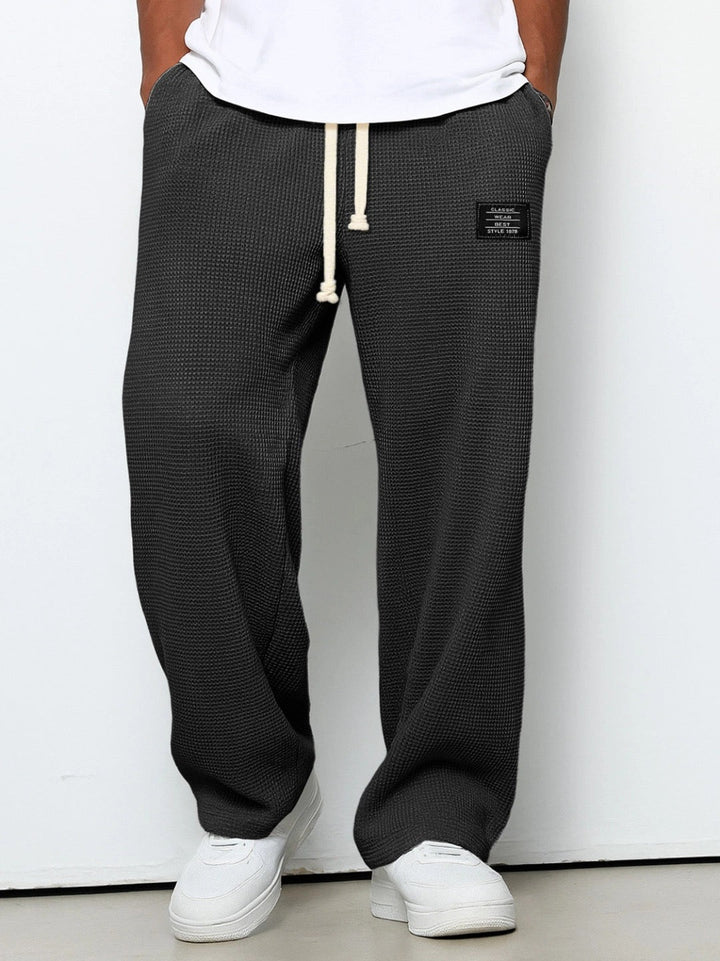 Wide leg trousers with adjustable drawstring waist and textured finish