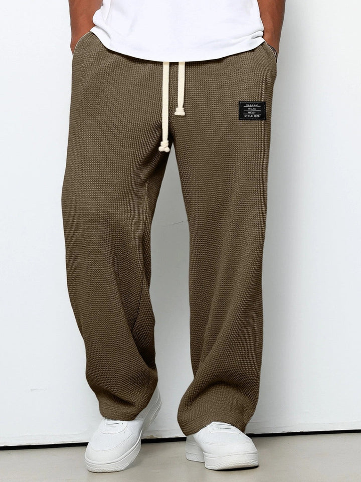Wide leg trousers with adjustable drawstring waist and textured finish