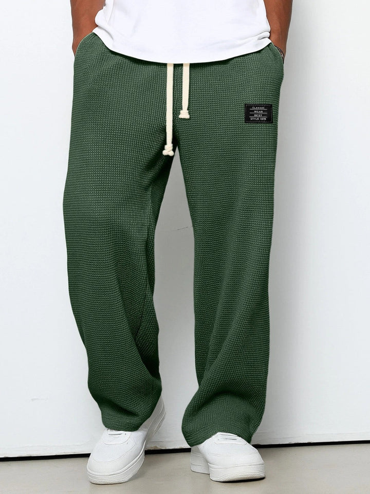 Wide leg trousers with adjustable drawstring waist and textured finish
