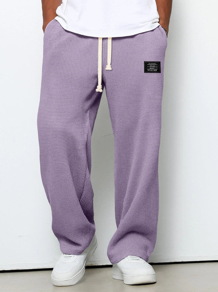 Wide leg trousers with adjustable drawstring waist and textured finish
