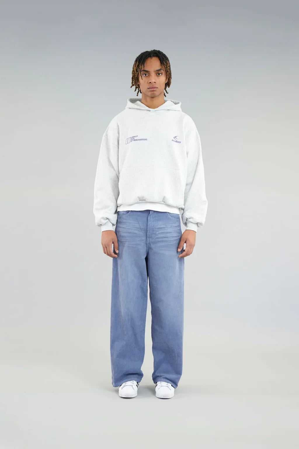Model wearing an oversized graphic pullover hoodie with hood, long sleeves and kangaroo pocket
