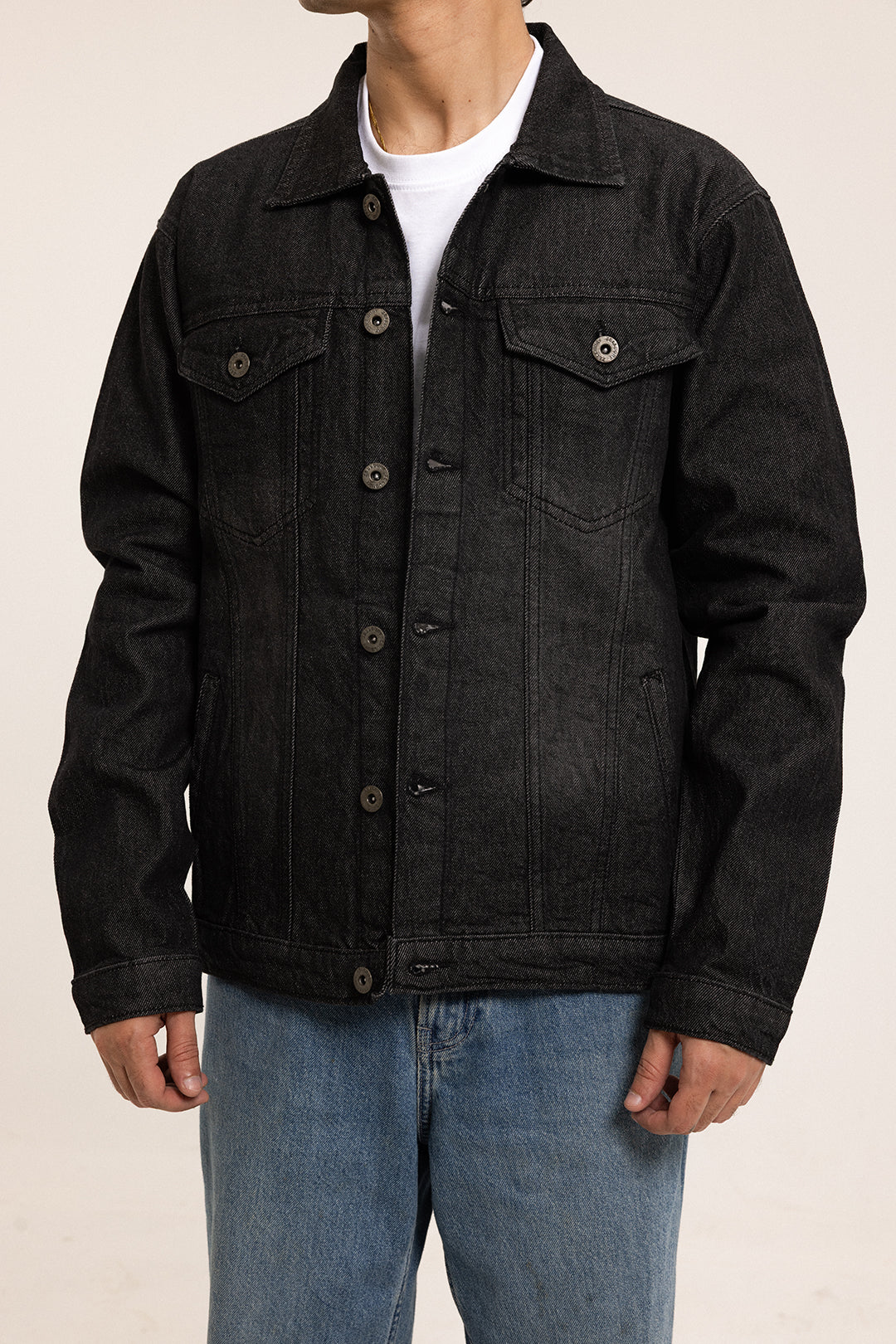 Men's black button-front denim jacket with pointed collar and chest pockets