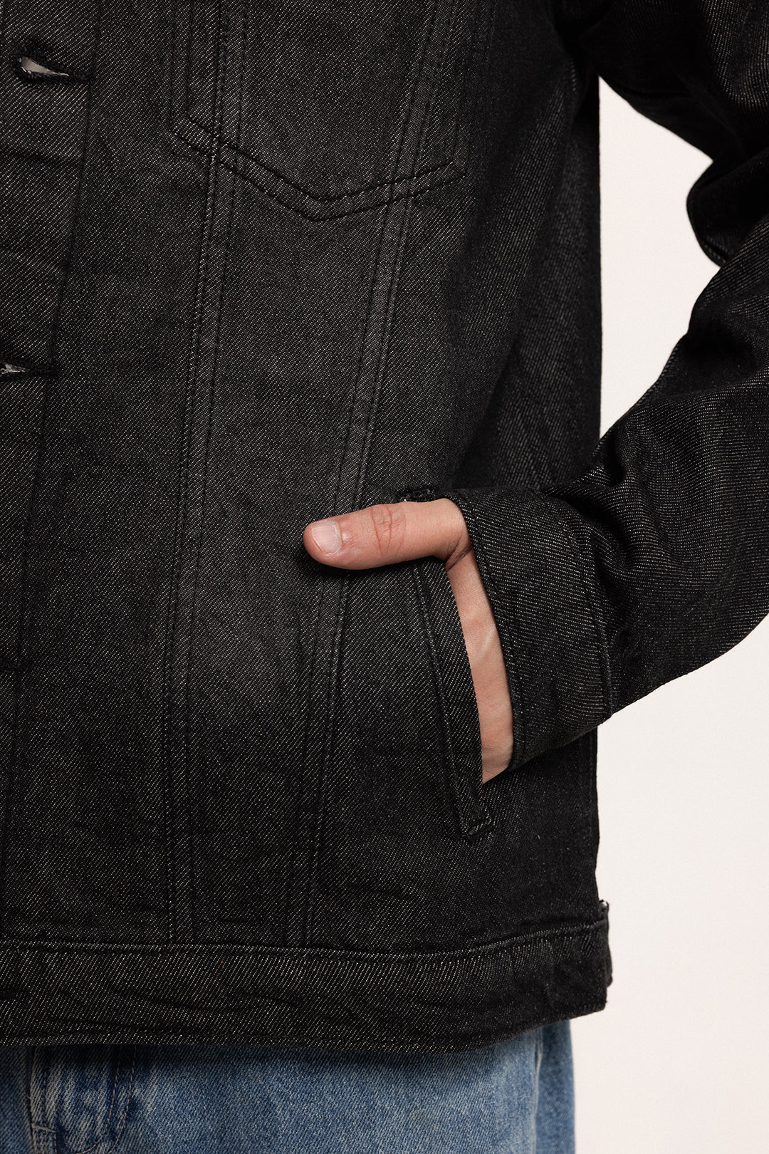 Men's black button-front denim jacket with pointed collar and chest pockets