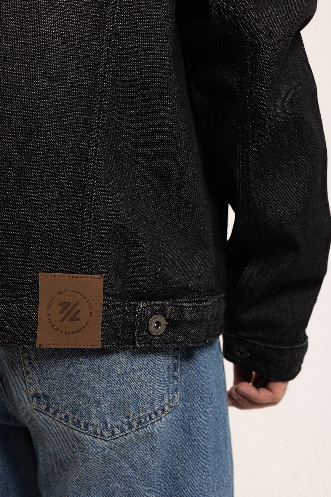Men's black button-front denim jacket with pointed collar and chest pockets