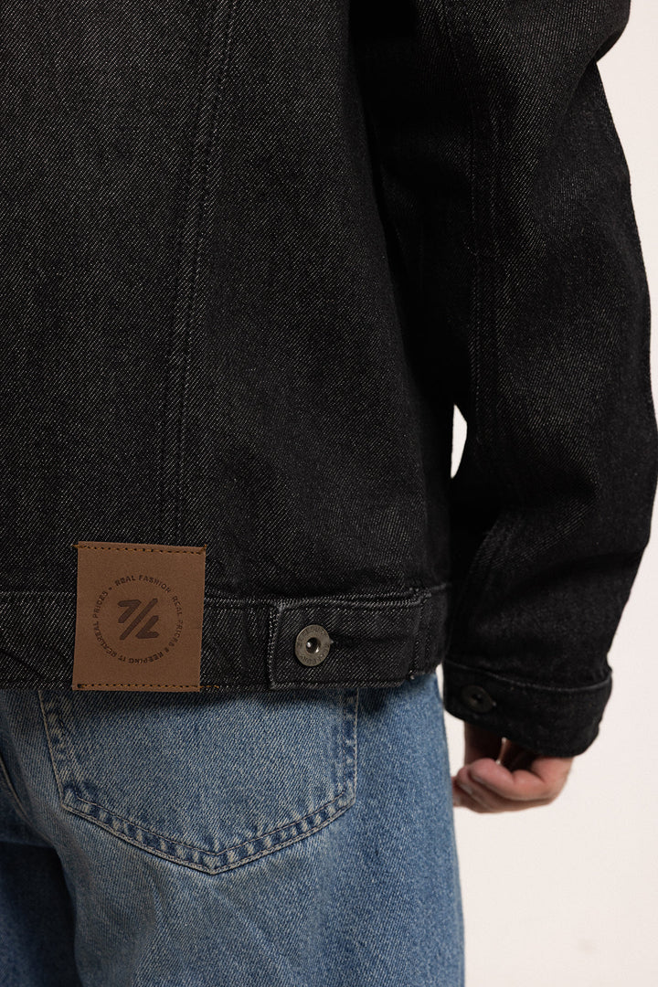 Men's black button-front denim jacket with pointed collar and chest pockets