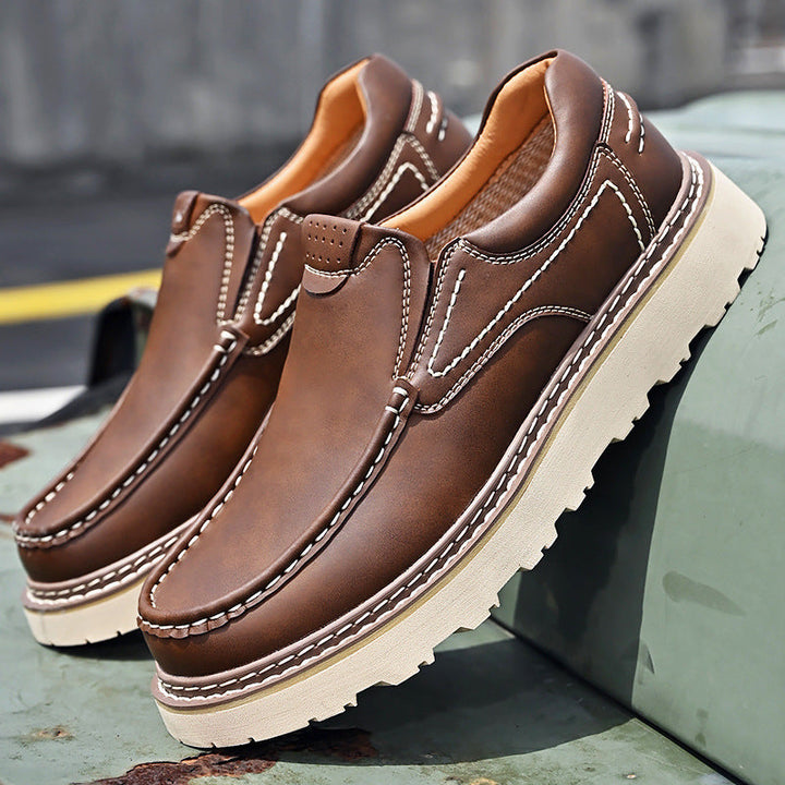 Brown and black moc-toe loafers with contrast stitching and lug soles